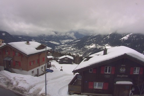 View over snow-covered chalet-style buildings in the village of Bellwald in Switzerland – Weather to ski – Snow report, 17 February 2022