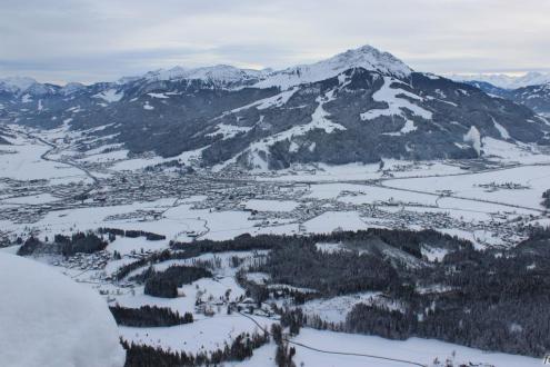 Panoramic view over the valley, and snow-covered ski slopes in St Johann in Tirol, Austria – Weather to ski – Snow report, 8 December 2023