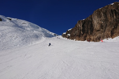 View up the Sarenne run with skier in the distance and perfect blue skies above, on 21 December 2021 – Weather to ski - Our blog: Alpe d’Huez – one of the best all-round ski resorts in the Alps?
