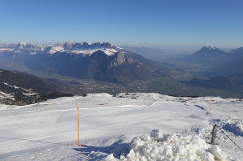 Panoramic view over the slopes and valley in Pizol, Switzerland, with snow-covered piste in the foreground and blue skies above – Weather to ski – Today in the Alps, 22 March 2022
