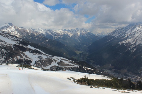View of snow-covered ski slopes in the ski resort of St Anton, with orange-tinged snow thanks to Saharan dust – Weather to ski – Today in the Alps, 16 April 2022