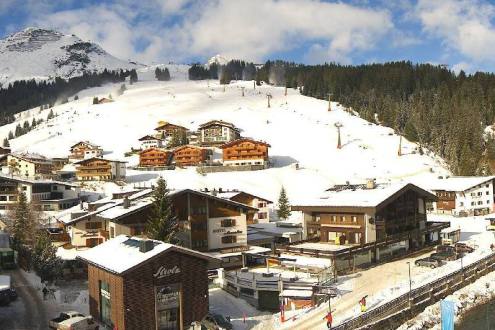 Slightly cloudy skies over Lech, Austria, looking over the village to the ski slopes beyond – Weather to ski – Today in the Alps, 7 December 2022