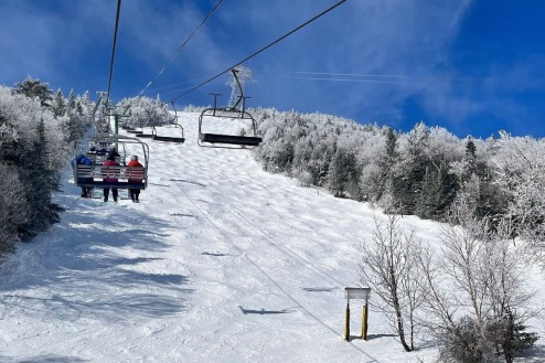 Skiers on chairlift above the slopes of Jay Peak, Vermont, USA on 20 March 2023 - Weather to ski – Who got the most snow in North America in 2022-23?