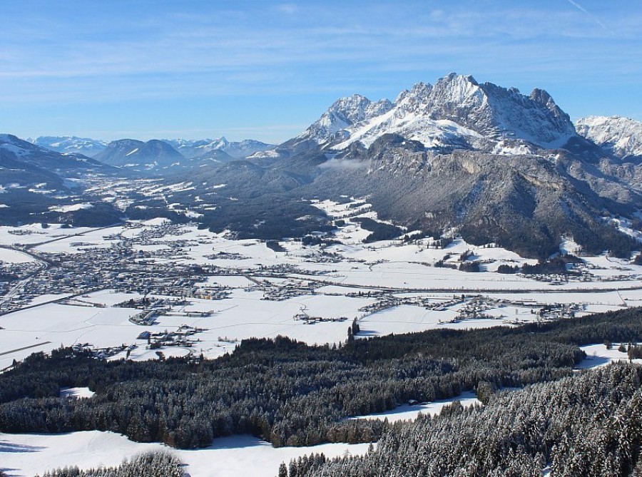 Blue skies above the snow-covered mountainside in St Johann in Tirol, Austria –  Click to view our latest weather & snow forecast from 28 November 2025