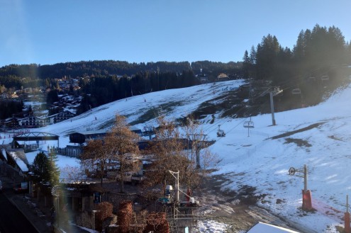 Resort level slopes in Les Gets, France, with threadbare snow cover - Link to Weather to ski's full "Today in the Alps" report on weather and snow conditions for 13 December 2025