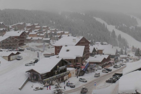 Cloudy skies over the snow-covered chalet-style buildings in the centre of Les Saisies ski resort in France – Weather to ski – Today in the Alps, 30 January 2026