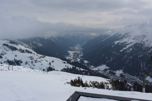 Cloudy skies above the snow-covered ski slopes, mountains and valley in St Anton, Austria – Weather to ski – Today in the Alps, 1 March 2026