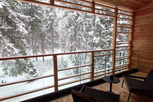 Snow accumulations on the trees in Champoluc, Italy, viewed from balcony of the Aethos Monterosa hotel – Link to Weather to ski's full "Today in the Alps" report on weather and snow in the Alps on 22 March 2026