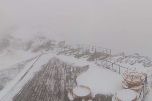 Fresh snow on tables and the mountainside at 3000m in La Plagne, France on the morning of 8 October 2026 - Link to Weather to ski's report on Today in the Alps on 8 October 2026