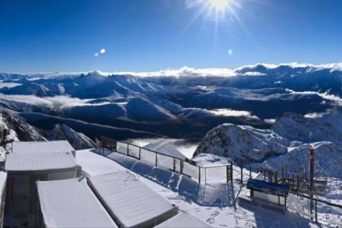 Significant fresh snow on the buildings and mountainside at high altitude in Alpe d’Huez, France
